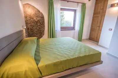 Letto o letti in una camera di Ginepro (Villa Capelvenere)