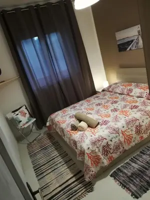 Letto o letti in una camera di APPARTAMENTO CORALLO with PRIVATE GARDEN