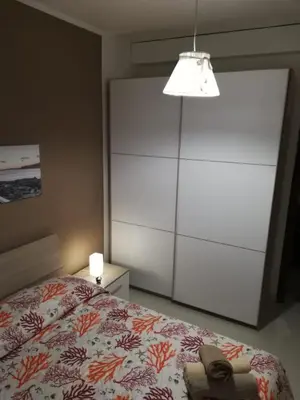Letto o letti in una camera di APPARTAMENTO CORALLO with PRIVATE GARDEN