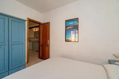 Letto o letti in una camera di Porto San Paolo Apartments
