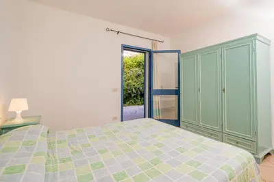 Letto o letti in una camera di Apartments in Residence with swimming pool in Cala Girgolu