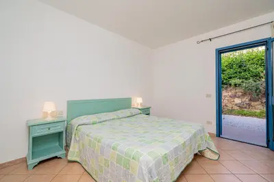 Letto o letti in una camera di Apartments in Residence with swimming pool in Cala Girgolu