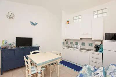 Cucina o angolo cottura di Porto Coda Cavallo Beach House a 300 mt dal mare, con terrazza panoramica