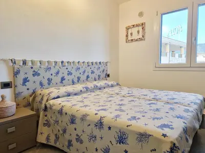 Letto o letti in una camera di Cedro - Appartamento in residence con piscina condivisa