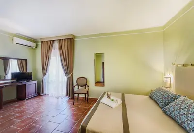 Letto o letti in una camera di Colonna Palace Hotel Mediterraneo