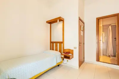 Letto o letti in una camera di Albergo Miramare