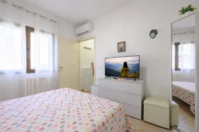 Letto o letti in una camera di Holiday Olbia - Appartamento a due passi dal lungomare e centro città