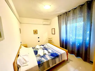 Letto o letti in una camera di APPARTAMENTO LA CALETTA VACANZE