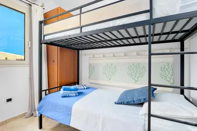 Letto o letti in una camera di Villetta Azzurro - SHERDENIA Luxury Apartments