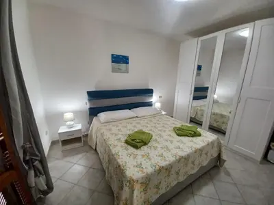 Letto o letti in una camera di CASA SIBILLA bi-locale con terrazza a 60 metri dal mare