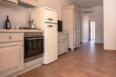 Cucina o angolo cottura di Le Residenze Del Golfo Di Orosei Bilo 5 - Happy Rentals