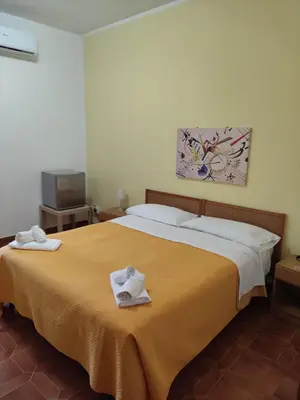 Letto o letti in una camera di Piccolo Hotel Nuova gestione