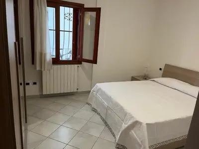 Letto o letti in una camera di Ampio bilocale