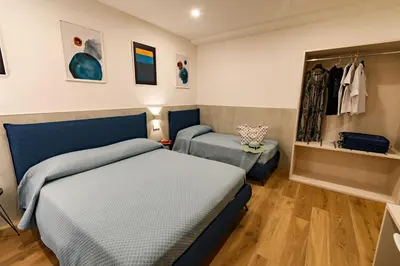 Letto o letti in una camera di Harbor Rooms - Cala Gonone