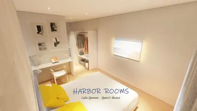 Letto o letti in una camera di Harbor Rooms - Cala Gonone