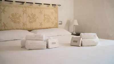 Letto o letti in una camera di MareSole La Cinta