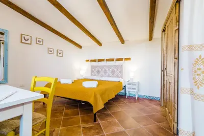 Letto o letti in una camera di Panoramic Loft con uso cucina ,Casa Raimonda, Ammentos Posada